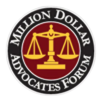 Emblem featuring golden scales of justice on a red background, encircled by black ring with white text "Million Dollar Advocates Forum.